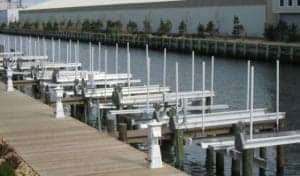 Long row of IMM Quality Alumavator Boat Lifts at a multi-slip marina