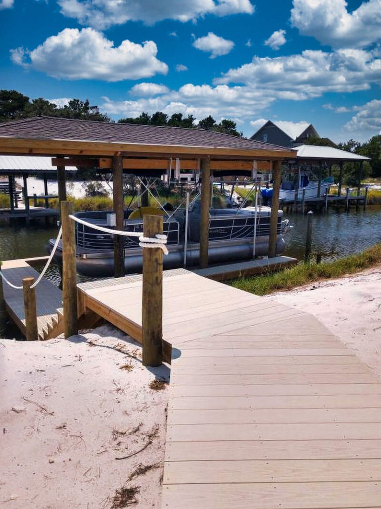 Side view of dock steps and pontoon boat in IMM Quality boathouse lift