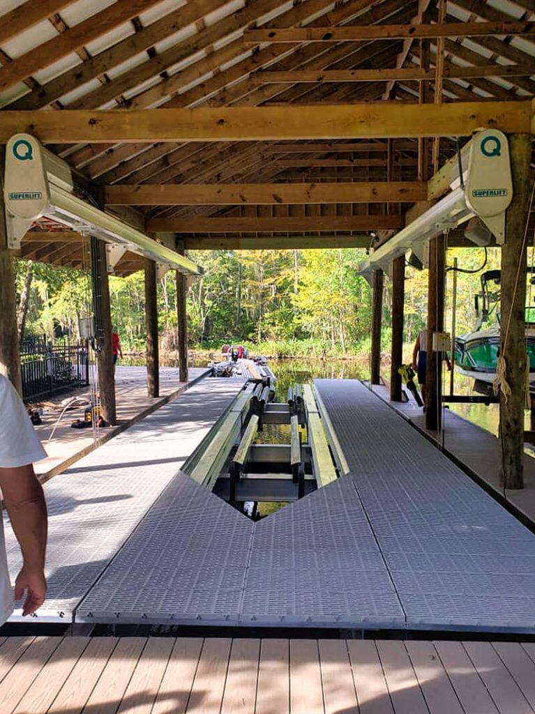 Large wooden boathouse covers the IMM Quality Superlift boathouse lift