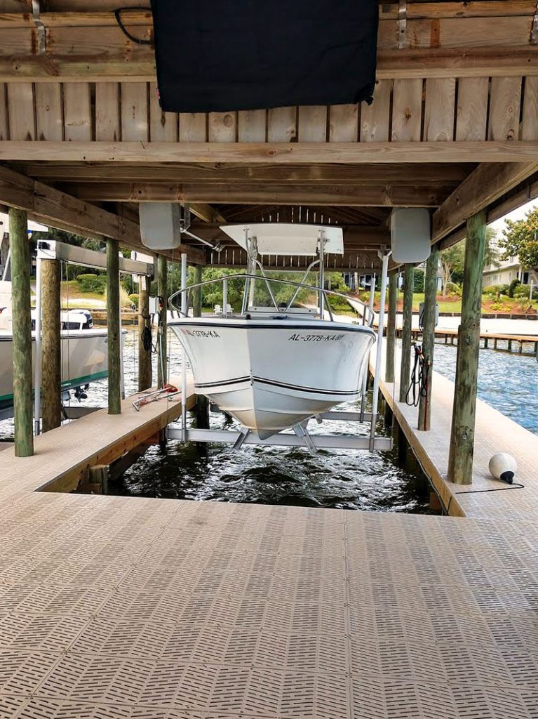 This custom boat house lift holds a large white yacht