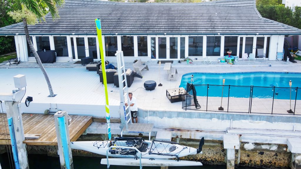 IMM Quality Boat Lifts employee completes seawall installation to add a kayak lift to this waterfront home