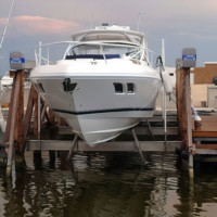 Large white yacht uses keel spreader and stanchions for custom boat lifts